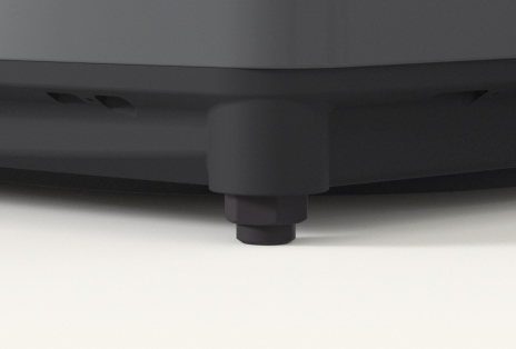 Close up of a washer adjustable foot ensuring stable placement.