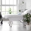Bright healthcare room with a treatment bed and wheelchair, emphasizing hygiene and care	