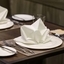 Restaurant table setting with neatly folded white napkins, highlighting professional hospitality	