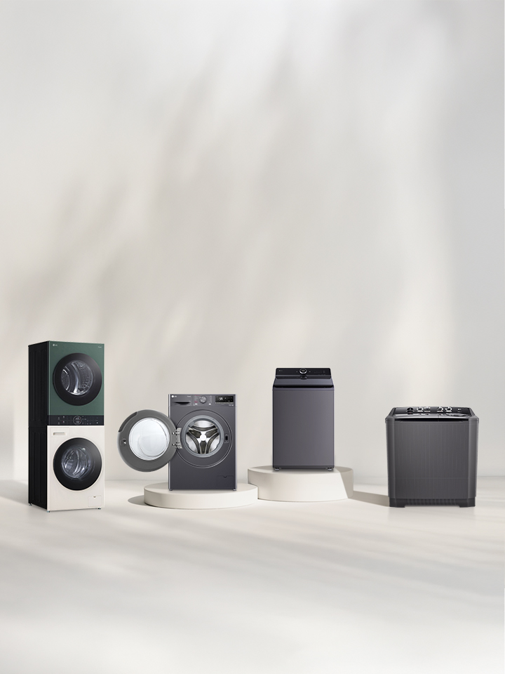 In front of the beige wall, there is the LG Wash Tower front loading washer, top loading washer, and twin washing machine lineup. On the right, you can see the forest view.