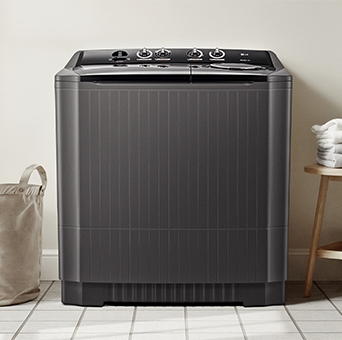 A twin washer is located in a large, white-tiled multipurpose room. To the right is a white washcloth.