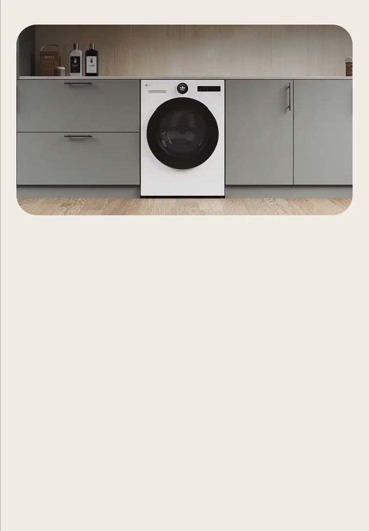 LG white front-loading washing machine built into gray cabinets in modern multipurpose rooms.