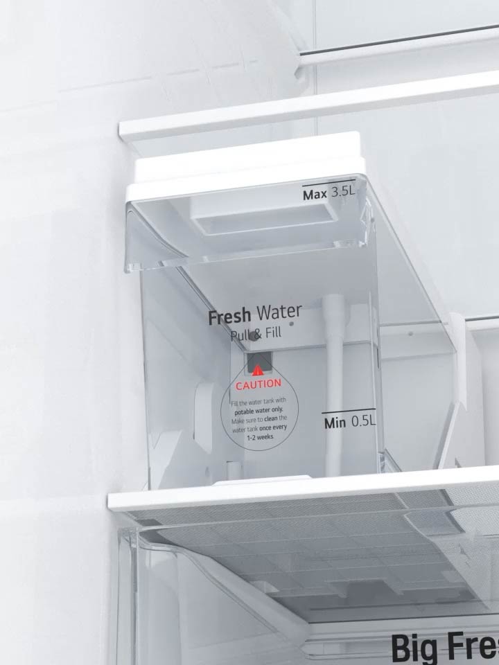 User opening the Slim SpacePlus Ice System compartment in an LG refrigerator.