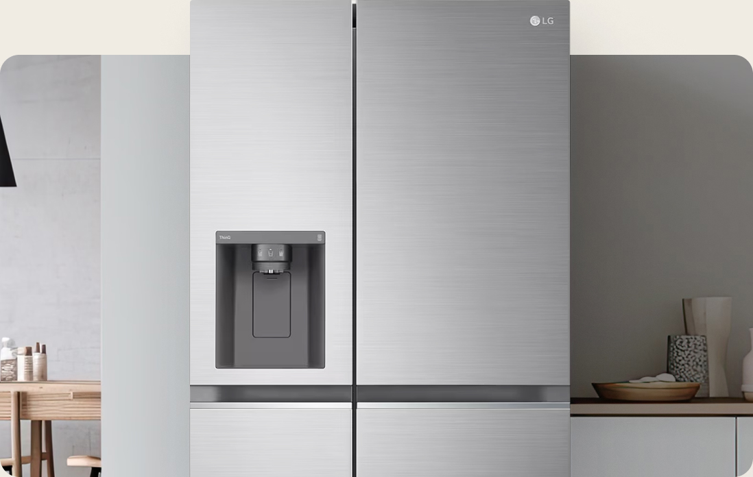 Close-up of an LG American-style fridge freezer in a silver finish, seamlessly integrated into a bright modern kitchen, highlighting a sleek water and ice dispenser.
