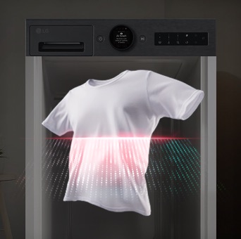 A red laser shines through a white T-shirt in the foreground, while a black LG washing machine stands in the background.