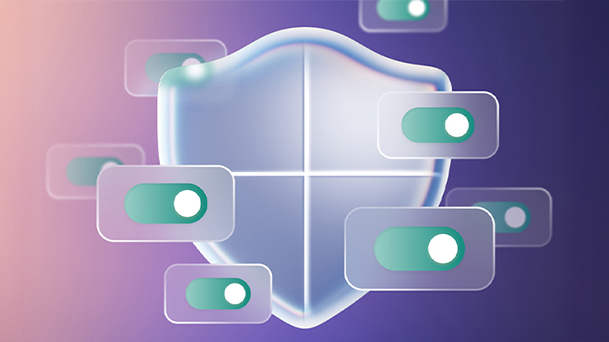 This image shows an laptop displaying the Windows 11 home screen with a large translucent shield icon overlay, symbolizing advanced security and protection features in Windows 11.