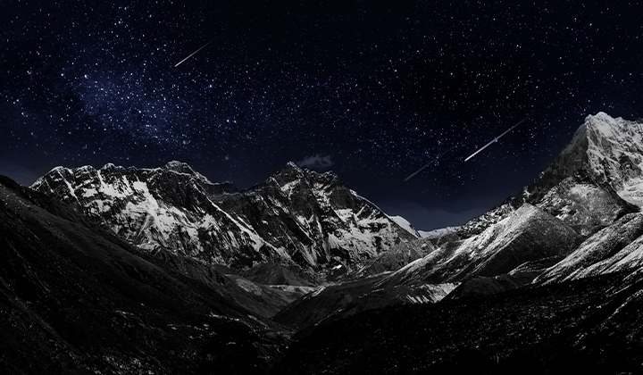 Mountain range with a dark evening sky filled with stars. The image is split in half, one side showing a duller, grayer version, the other side showing a more pleasing picture with greater dynamic range of blacks and whites. Logo certification is visible, Perfect Black Technology delivers black levels less than or equal to 0.24 nit up to 500 lux. 
