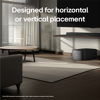 LG Sound Suite W7 woofer placed below a TV with a soundbar, showing easy wireless sound expansion for an immersive home stereo audio system