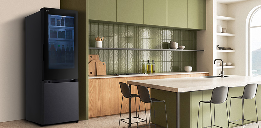 The side view of lg bottom freezer refrigerator with instaview in a kitchen with green cabinets and a stylish island.