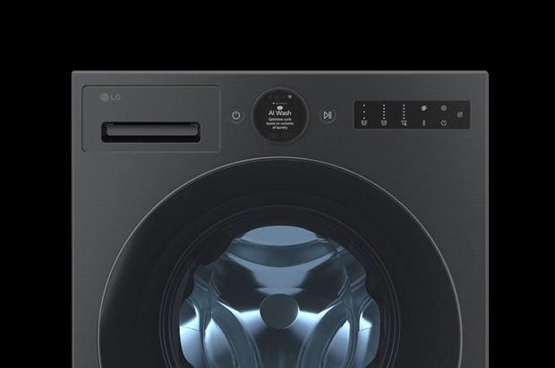 In front of the beige wall, there is the LG Wash Tower, front loading washer and top loading washer. On the right, you can see the forest view.	