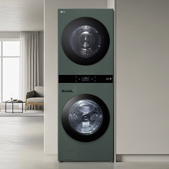 LG WashTower with green design, neatly installed. Surrounding it are organised clothes, baskets, and household items.	