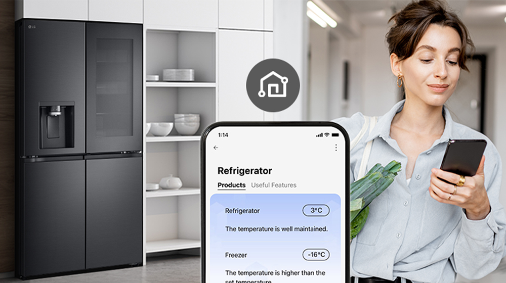 Modern black LG refrigerator in a sleek kitchen, with a smartphone displaying its temperature settings.