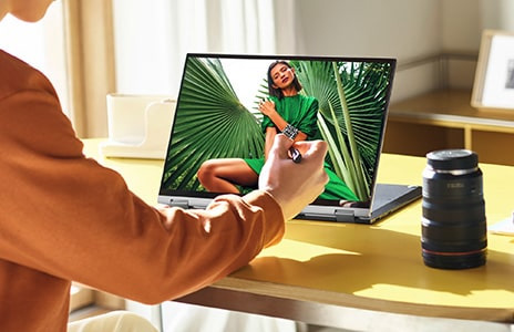 Person in brown clothes usees stylus pen on LG gram 2-in-1 laptop