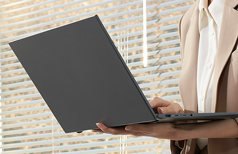 Laptop in hands of user  walking while using it. 