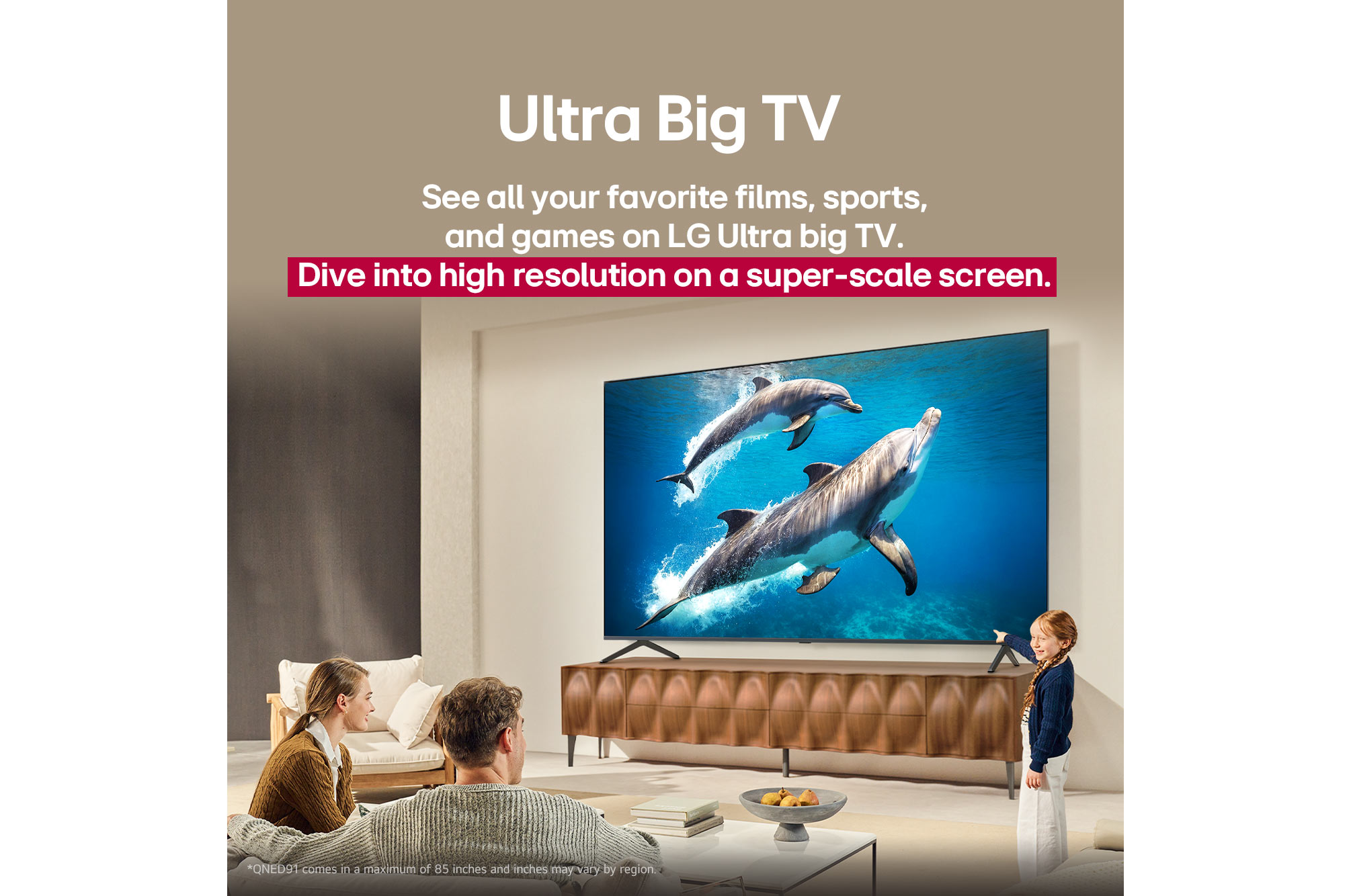 A family sits on a couch facing a LG QNED TV sitting above a TV stand with a little girl pointing to a screen depicting two dolphins. The title talks about how you can enjoy high resolution on a massive screen.