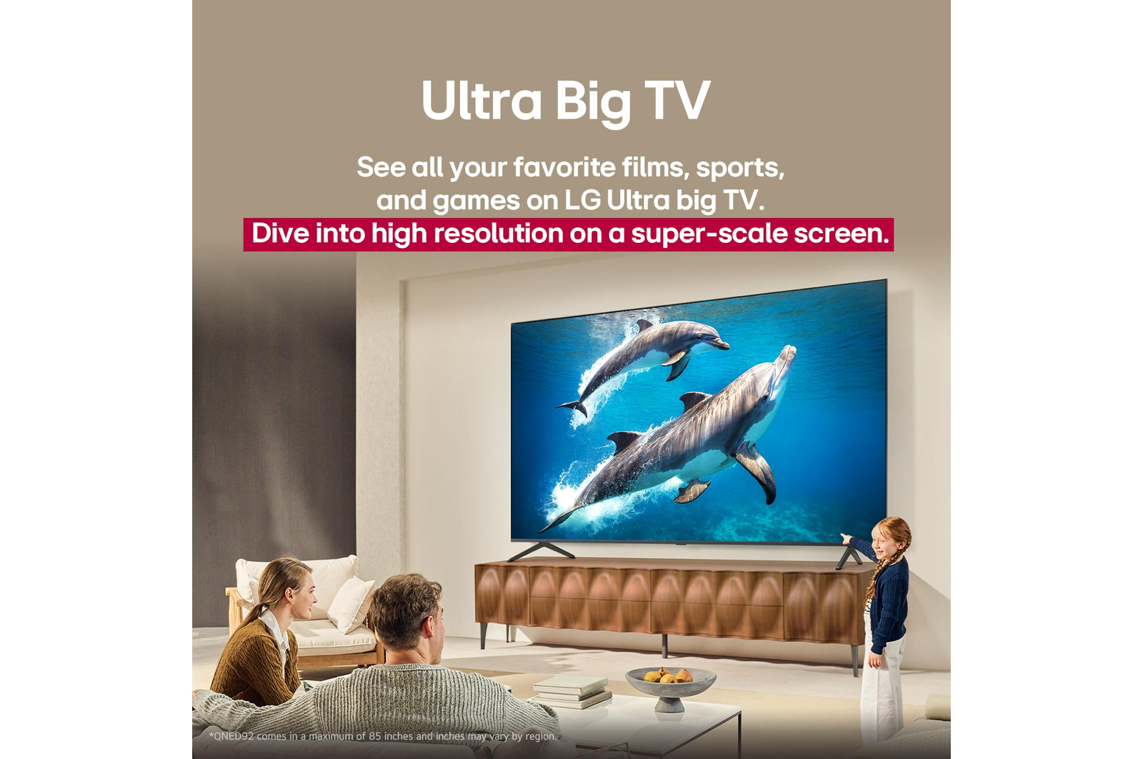 A family sits on a couch facing a LG QNED TV sitting above a TV stand with a little girl pointing to a screen depicting two dolphins. The title talks about how you can enjoy high resolution on a massive screen.