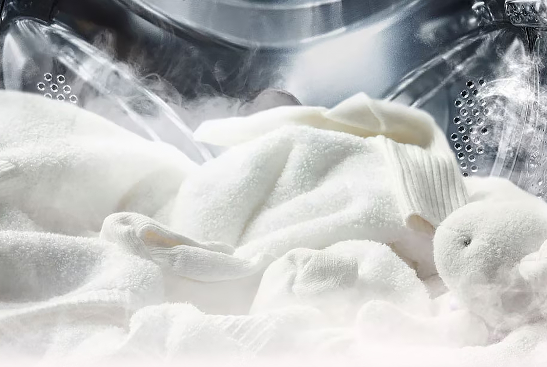 Close-up of soft white laundry with visible steam inside an LG drum illustrates steam technology for gentle care.