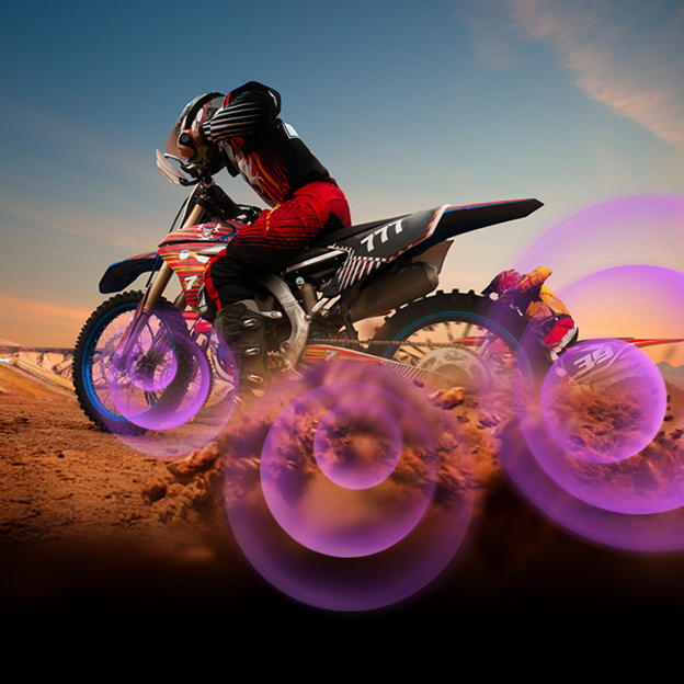 LG TV image with purple sound waves around a motorcycle rider illustrates Dynamic Sound Booster's fuller audio