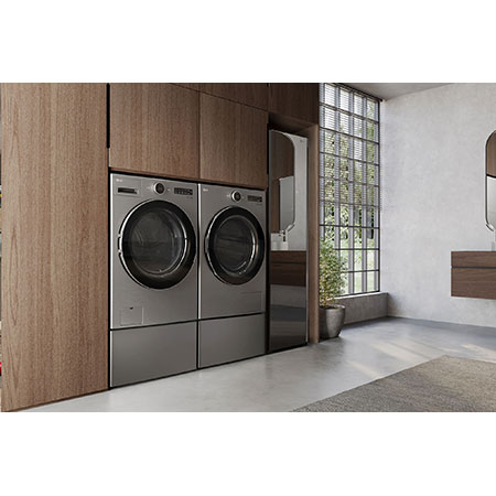 The LG Front Load Washer and Dryer set (DLHC5502V) in Graphite Steel, showcasing its premium aesthetic and seamless, flush integration into modern wood cabinetry.