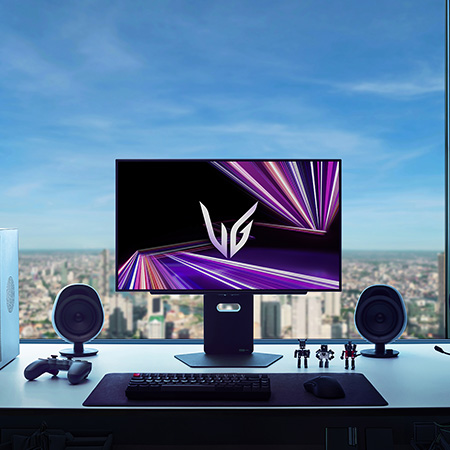 LG Monitor 27GX790A positioned at the center of a premium gaming setup, featuring a dark room ambiance with a city skyline view and optimized peripherals for immersive gaming.