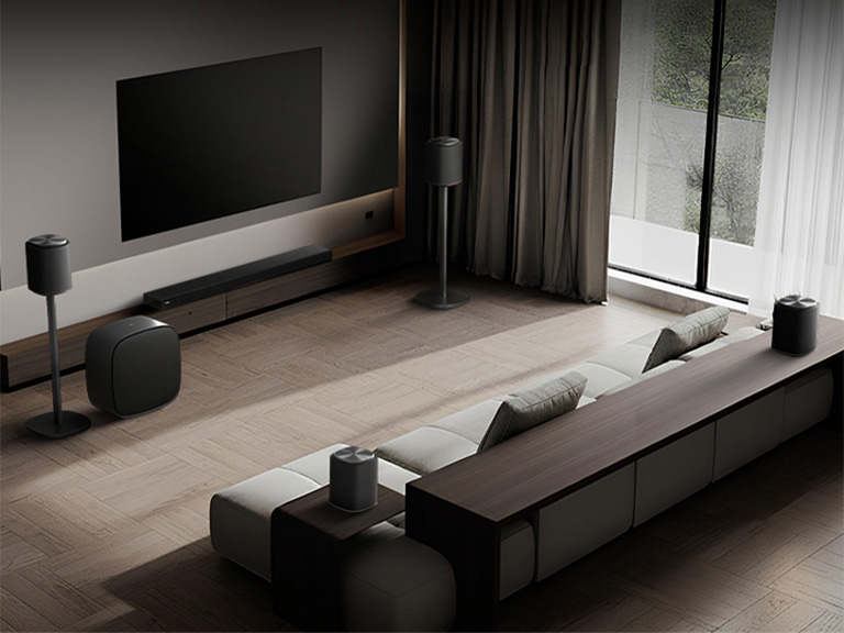 A living room with LG Sound Suite speakers, a soundbar and a woofer emitting pulsing sound waves to create a Dolby Atmos home theater system