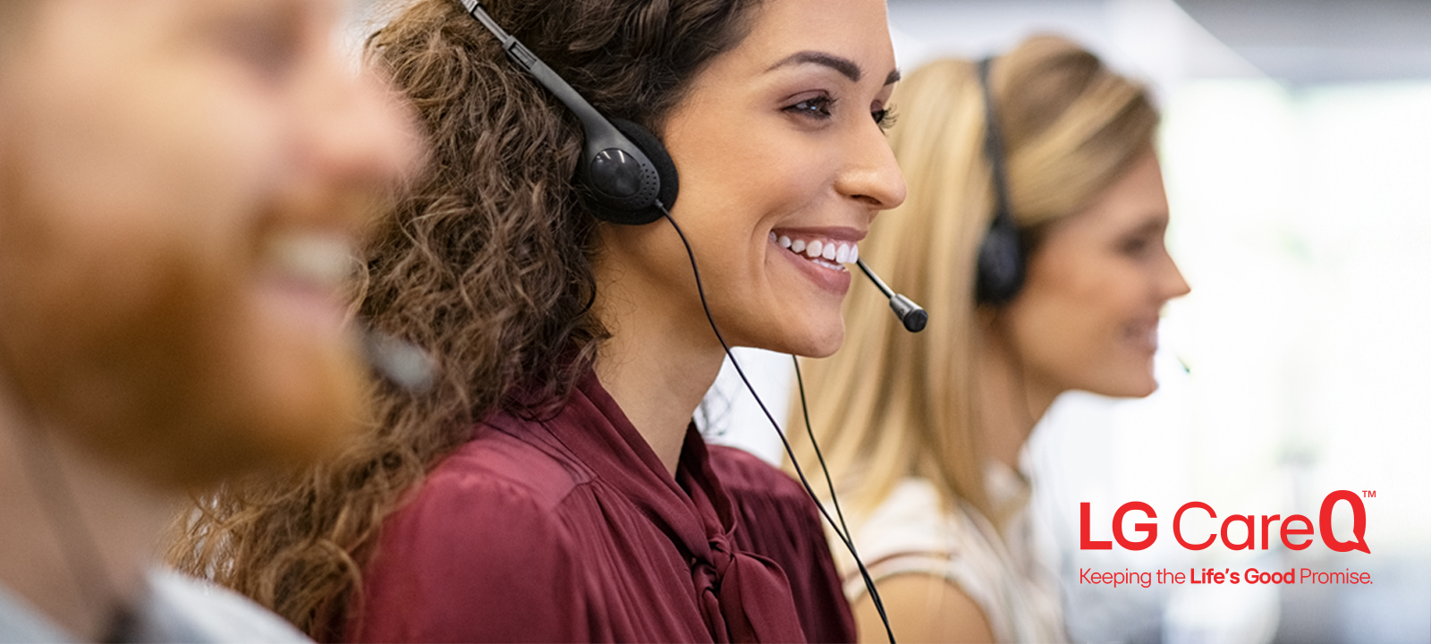 Smiling customer support agents wearing headsets, representing LG CareQ™, which provides expert appliance support from real-time assistance to in-home service, helping customers keep their LG appliances performing their best.