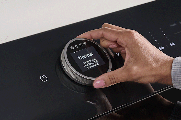 Close-up of a black LG washing machine digital dial control with an LCD display showing cycle settings.