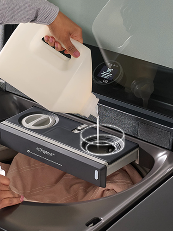 Black steel LG top-load washing machine with an open lid showing the ezDispense detergent and softener compartments.