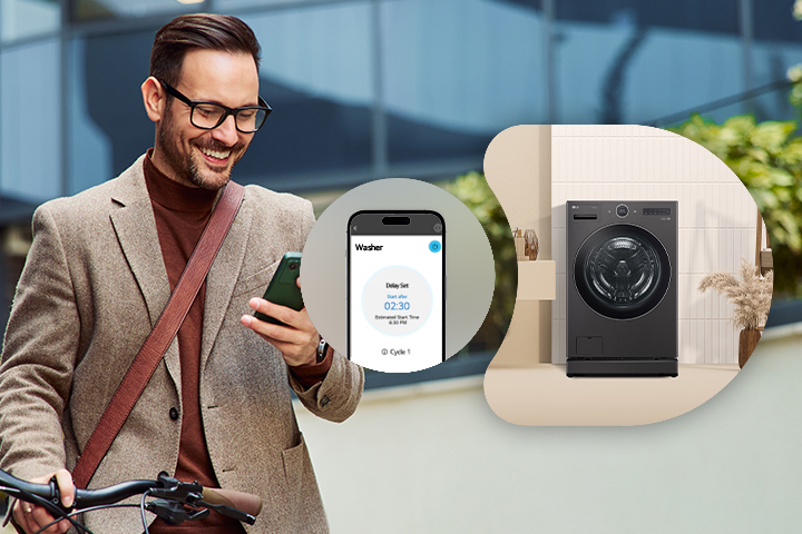 Black steel LG WashTower stacked laundry center with a central control panel and a smartphone showing the ThinQ app.