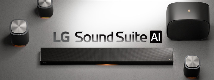 Top-down view of LG Sound Suite spatial audio system on a matte silver surface, showing speakers, subwoofer, and a wireless soundbar.