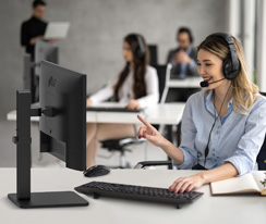 A woman with a headset talking to customer in call center.