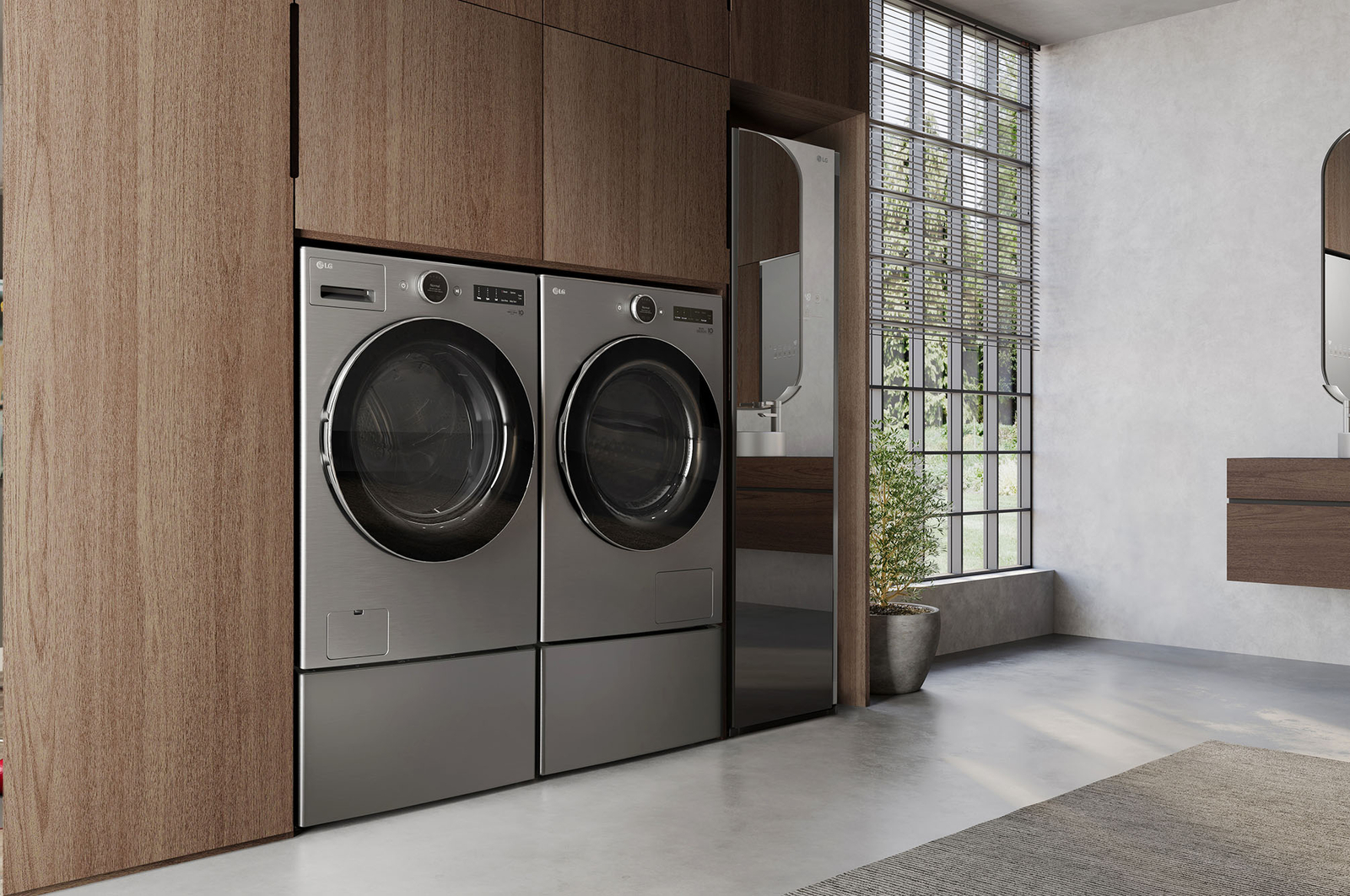 L'ensemble lave-linge et sèche-linge frontal LG (DLHC5502V) en Acier Graphite, mettant en valeur son design premium et son intégration parfaite et affleurante dans des armoires en bois modernes.