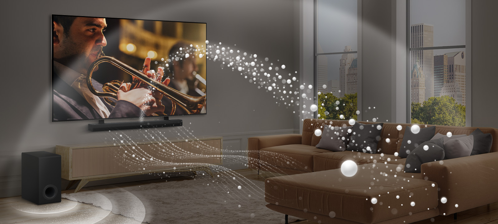 Une barre de son LG, un téléviseur de LG et un caisson de basses se trouvent dans un appartement urbain moderne. La barre de son LG projette trois branches d’ondes sonores composées de gouttelettes blanches qui flottent au-dessus du sol. D’autres ondes sonores composées de gouttelettes blanches sont projetées à partir de la partie supérieure de la barre de son. À côté de la barre de son se trouve un caisson de basses, qui crée un effet sonore à partir du bas. Ensemble, ils créent un effet de dôme dans la pièce.