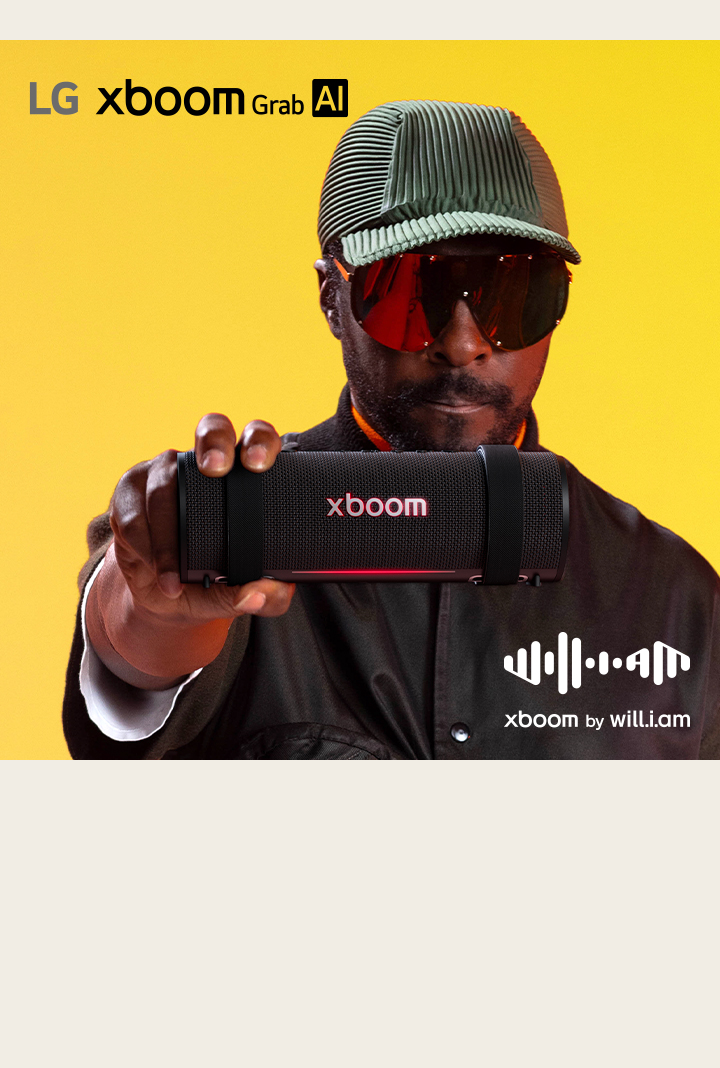 يظهر will.i.am مرتديًا زيًا أسود ونظارات شمسية، وهو يحمل جهاز xboom Grab إلى الأمام.
