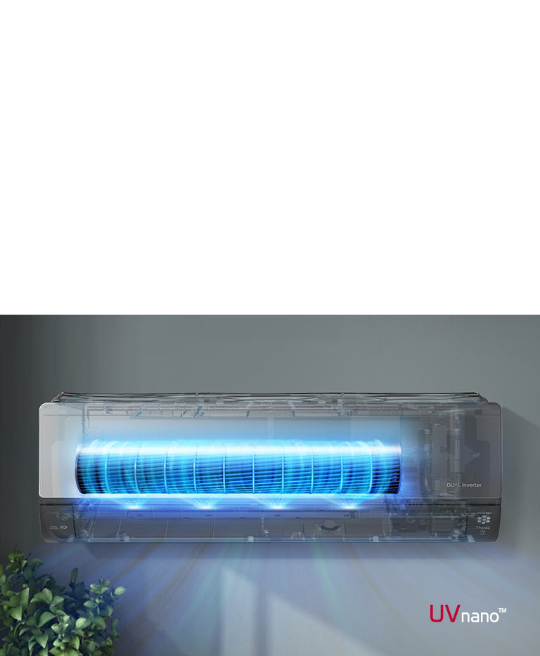 LG Dual Inverter air conditioner with UVnano technology emits a blue glow, mounted on a grey wall above green plants.