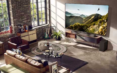 A 2023 LG OLED evo TV in a neatly organized living room with a variety of furniture
