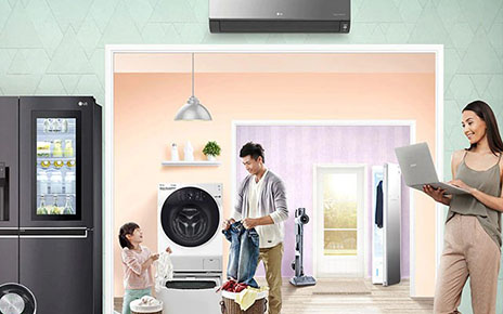 A family of three do the housework in a room filled with LG home appliances, including the LG AI DD Washing Machine