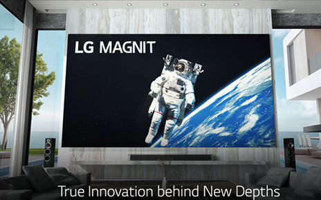 LG MAGNIT hanging on the wall of a modern living room as it displays an astronaut floating in space