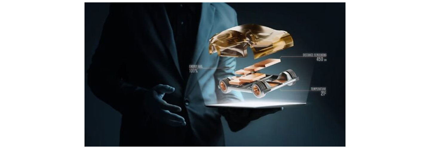A person holding a figure of an automobile separated into small parts