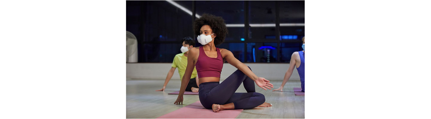 People wearing LG PuriCare™ Wearable Air Purifier during a Yoga session to enjoy the clean and fresh air while protecting themselves.