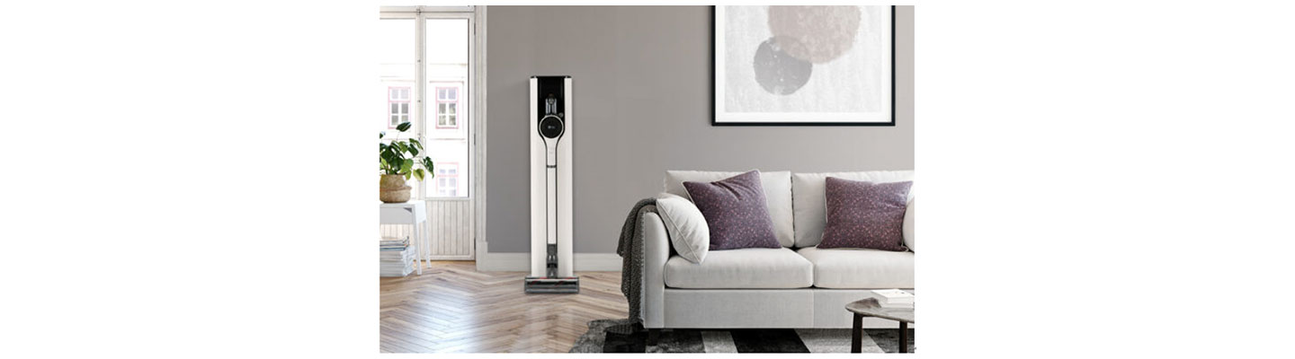 A photo of the CordZeroThinQ A9 Kompressor+ on its charging stand in a living room.