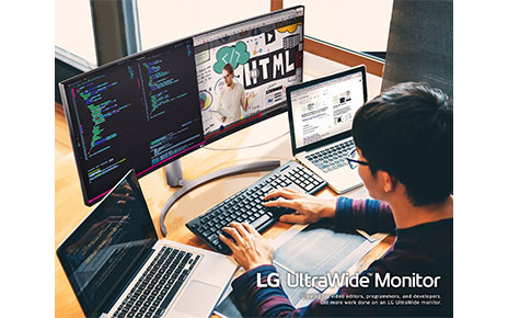 A computer programmer using the LG UltraWide Monitor with two laptops to multitask while working from home.