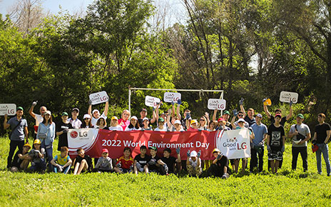 Staff of LG Kazakhstan and children from Almaty Regional Orphanage posing together for a photo after the planting activity