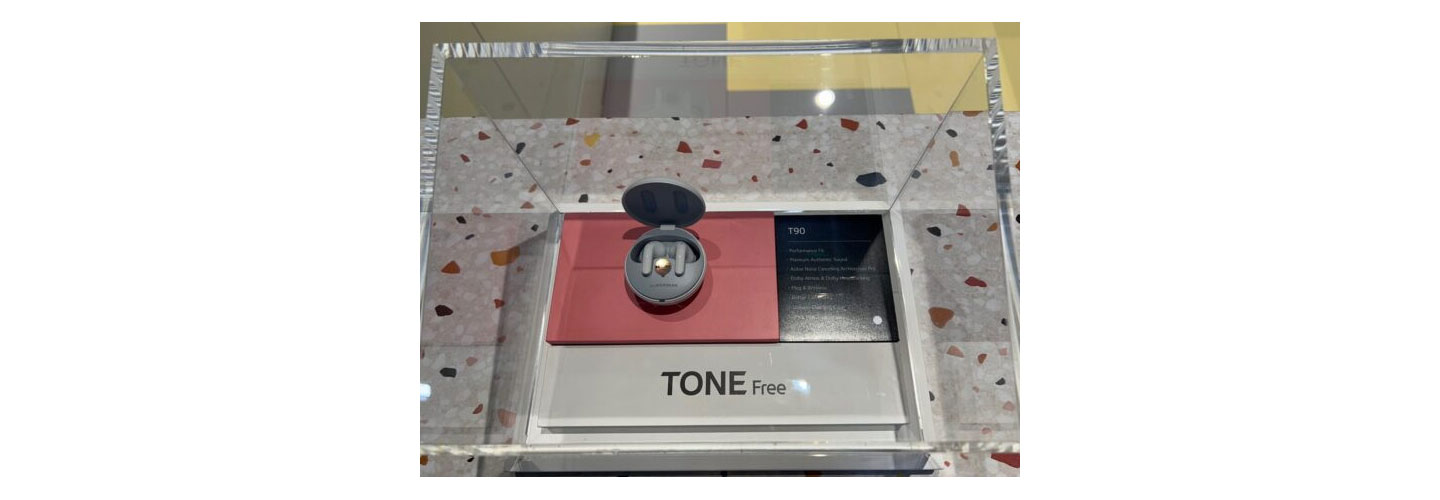 Close shot of the LG TONE Free earbuds (model T90) displayed under glass at LG's booth at IFA 2022.