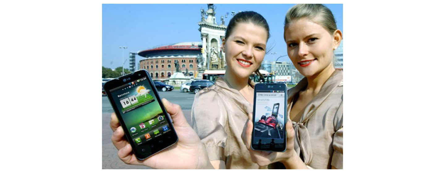 Two women pose with the LG Optimus 2X