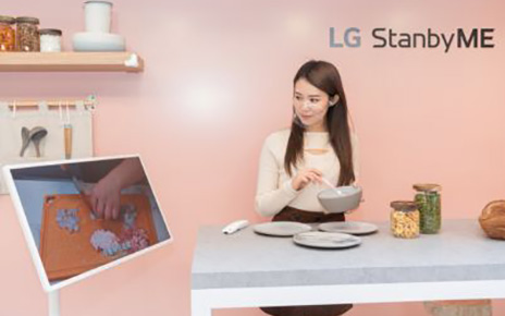 The Hong Kong launch event’s Kitchen Zone with a woman preparing a meal with the help of a cooking video displayed on LG StanbyME.