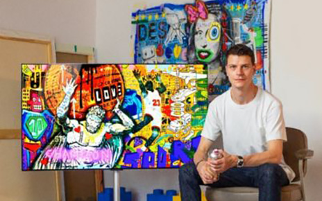 French pop street artist Jisbar with his artwork displayed on LG OLED TV.