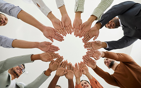 A group of people putting their hands together showing unity