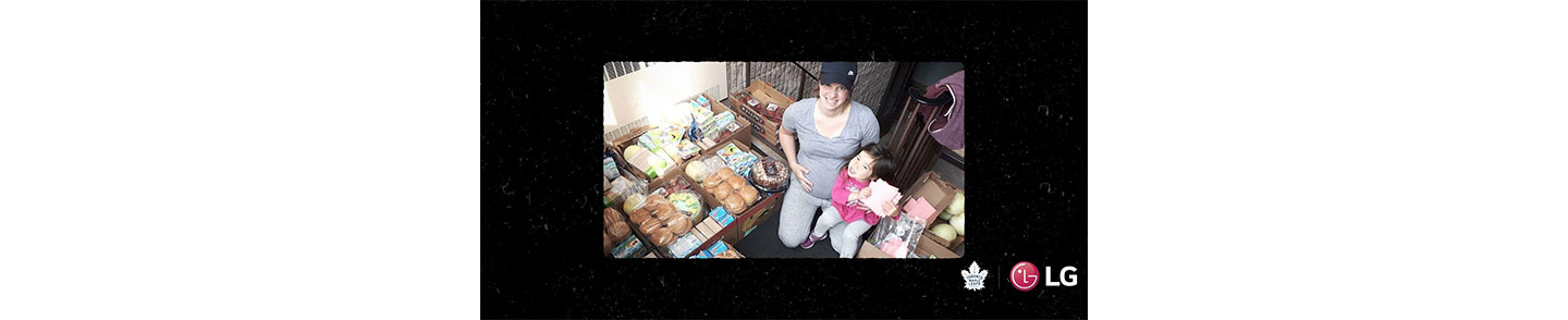 Local hero Janelle Jong and her daughter posing with food that has been donated to help feed hungry people in their community.