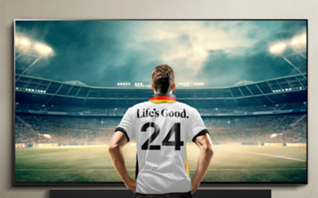 An illustration of a back of a man in a soccer uniform with Life's Good written on it on a TV screen 